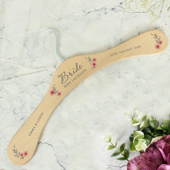 Buy Personalised Pink Floral Wooden Hanger at www.giftsfinder.co.uk