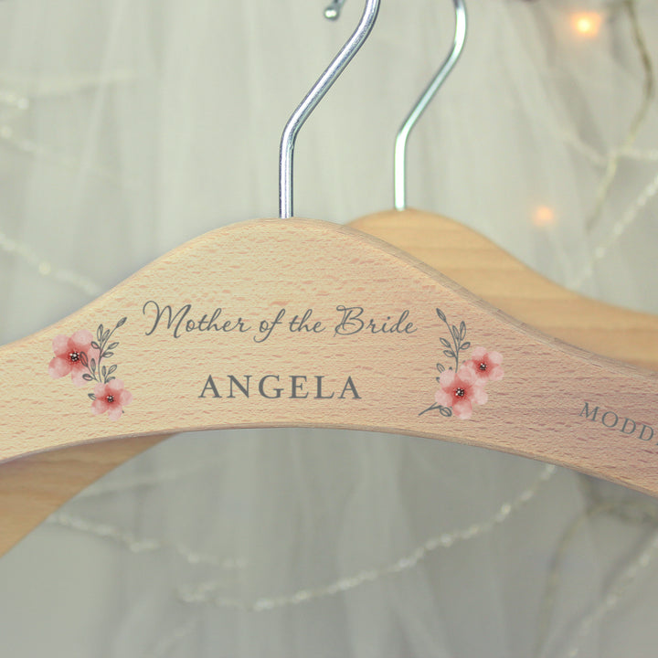 Buy Personalised Pink Floral Wooden Hanger at www.giftsfinder.co.uk