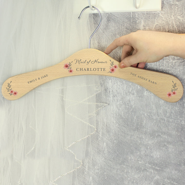 Buy Personalised Pink Floral Wooden Hanger at www.giftsfinder.co.uk