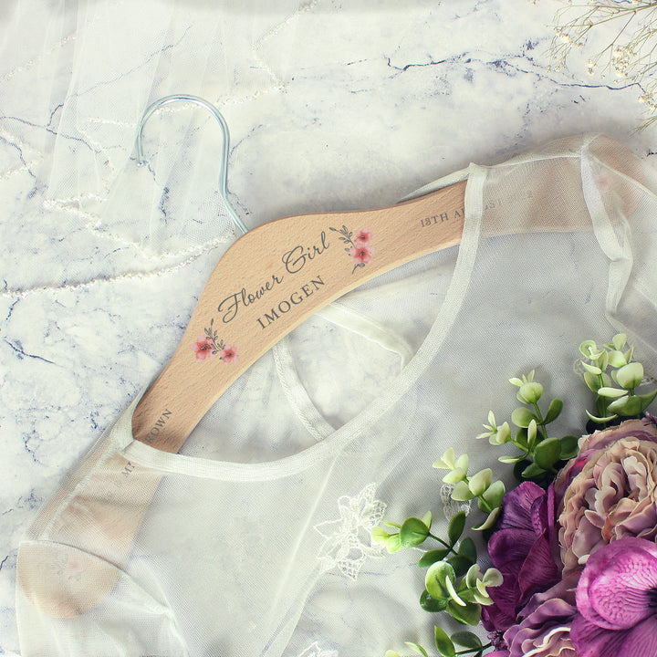 Buy Personalised Pink Floral Wooden Hanger at www.giftsfinder.co.uk