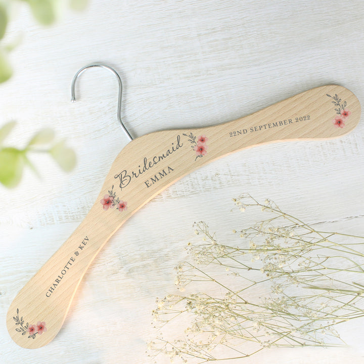 Buy Personalised Pink Floral Wooden Hanger at www.giftsfinder.co.uk