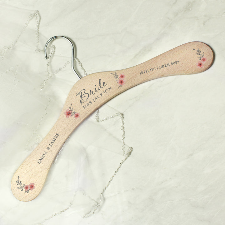 Buy Personalised Pink Floral Wooden Hanger at www.giftsfinder.co.uk