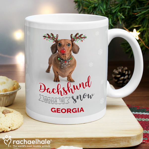 Buy Personalised Rachael Hale Christmas Dachshund Through the Snow Mug at www.giftsfinder.co.uk