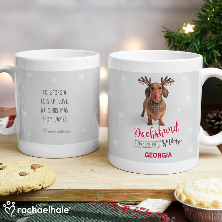 Buy Personalised Rachael Hale Christmas Dachshund Through the Snow Mug at www.giftsfinder.co.uk